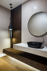 Bathroom renovation by Square One Construction. Circle mirror. Bathroom design.