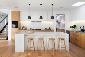 White and wood kitchen renovation by Square One Construction.