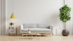 Living room with gray sofa on empty white wall background.